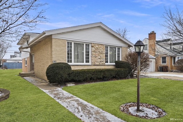 view of front of property featuring a garage and a front yard