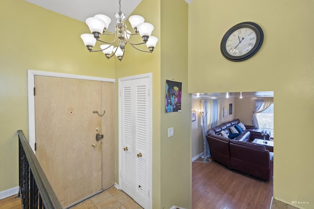 entrance foyer with an inviting chandelier, hardwood / wood-style flooring, and a high ceiling