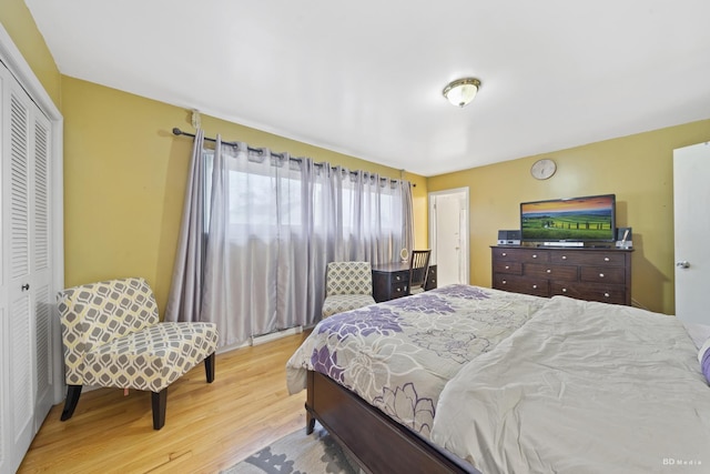 bedroom with light hardwood / wood-style flooring and a closet