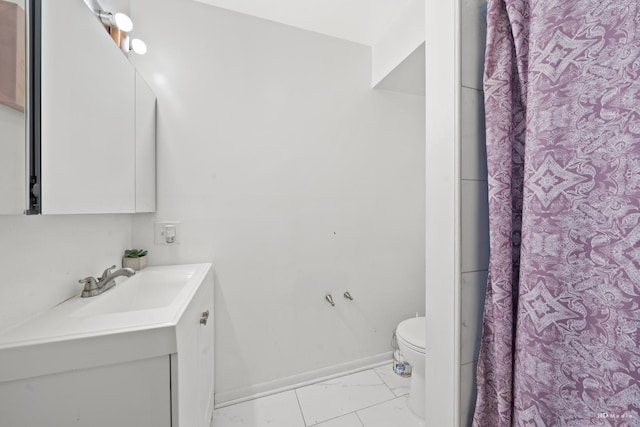 bathroom with walk in shower, vanity, and toilet