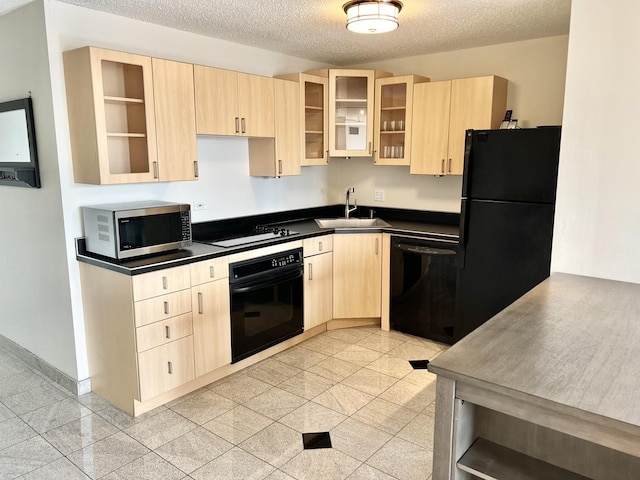 kitchen with sink, a textured ceiling, light brown cabinetry, and black appliances