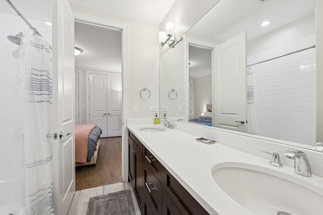 bathroom featuring vanity, hardwood / wood-style floors, and a shower with curtain