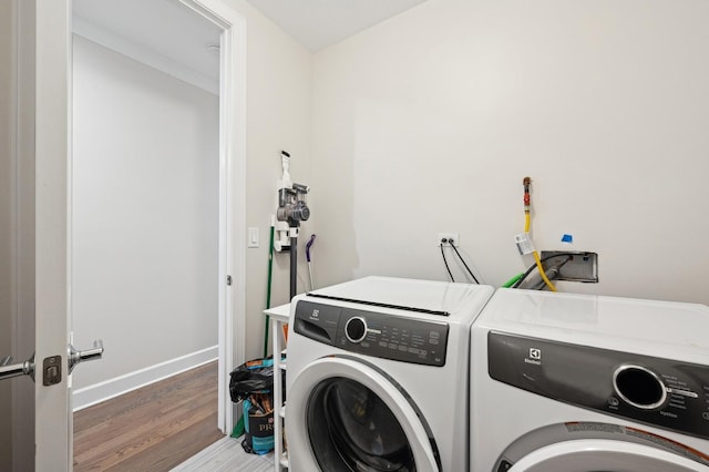 washroom with dark wood-type flooring and washer and dryer