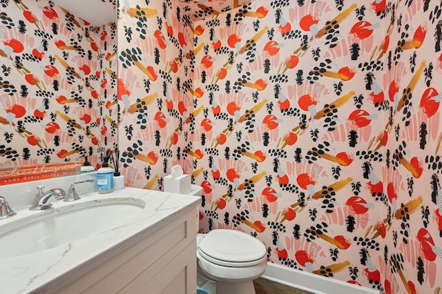 bathroom with vanity, hardwood / wood-style flooring, and toilet