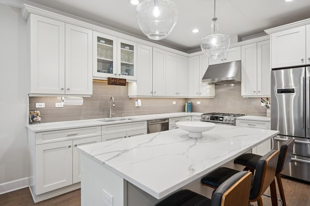 kitchen featuring sink, appliances with stainless steel finishes, extractor fan, white cabinets, and decorative light fixtures