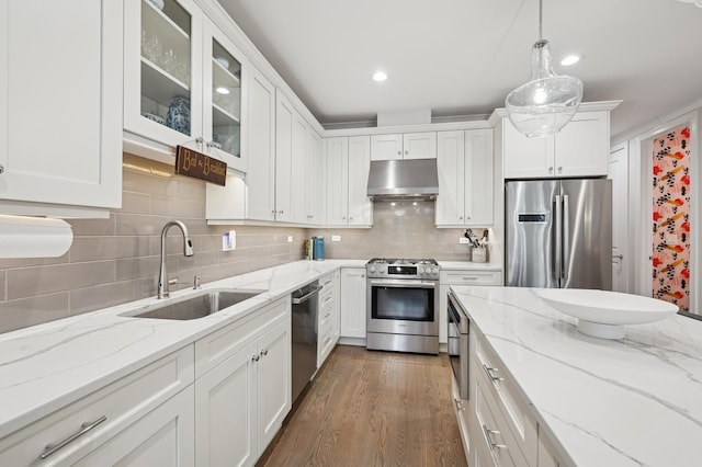 kitchen with stainless steel appliances, hanging light fixtures, and white cabinets