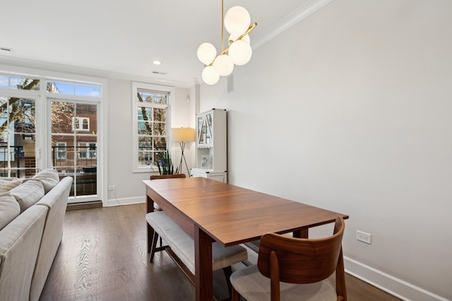 dining area featuring dark hardwood / wood-style floors and a chandelier