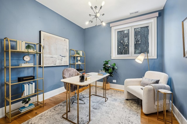 office space with an inviting chandelier and hardwood / wood-style floors