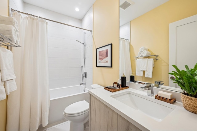 full bathroom with shower / tub combo with curtain, vanity, and toilet