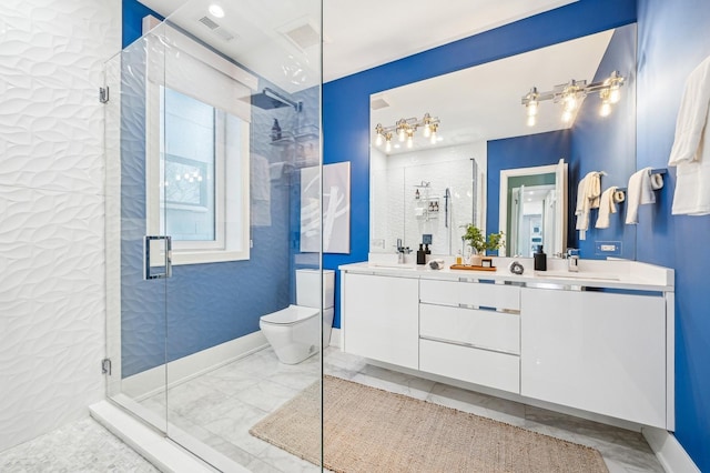 bathroom with vanity, a shower with door, and toilet