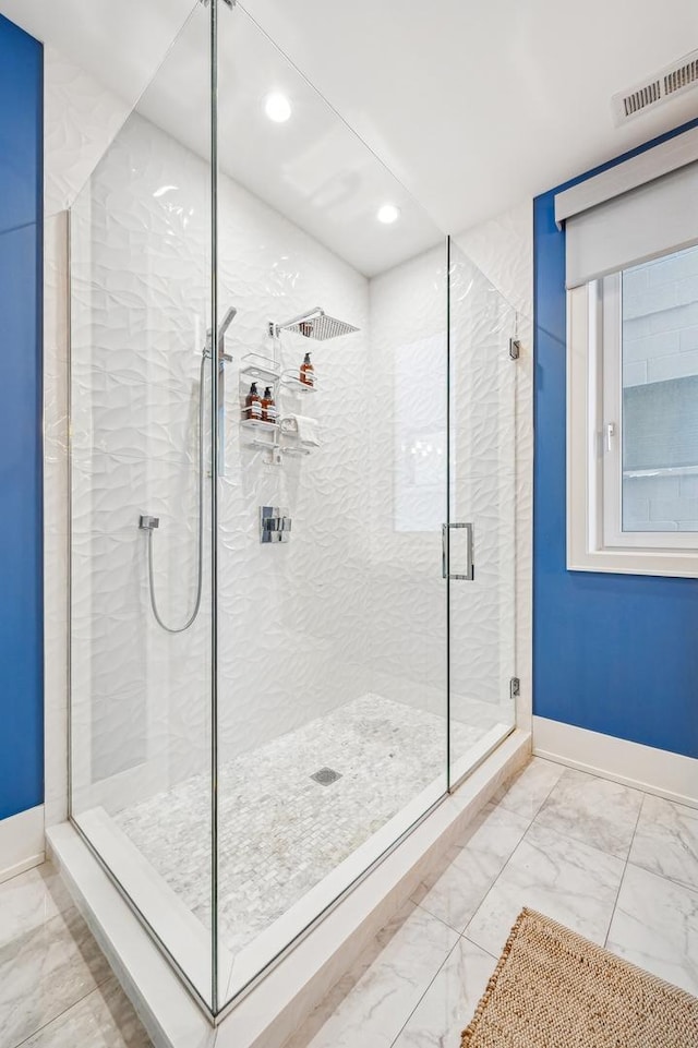 bathroom with a shower with shower door