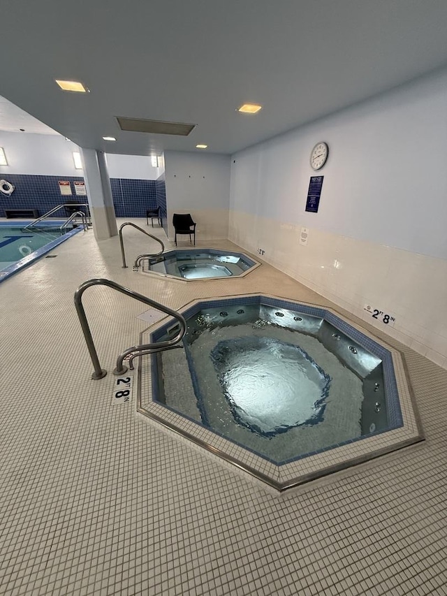 view of swimming pool featuring an indoor in ground hot tub