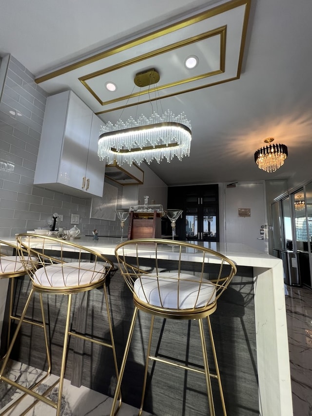 bar featuring white cabinetry and decorative backsplash