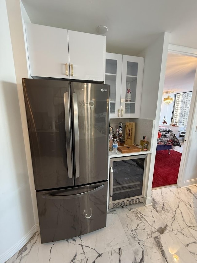 kitchen with wine cooler, stainless steel fridge, and white cabinets