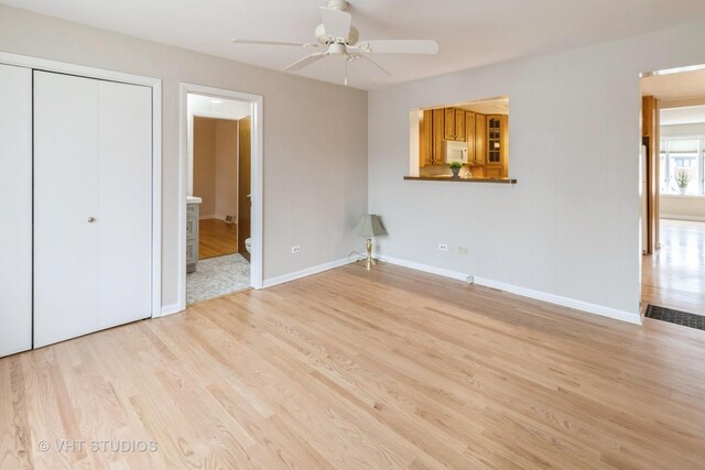 unfurnished bedroom with ceiling fan, ensuite bathroom, light hardwood / wood-style floors, and a closet