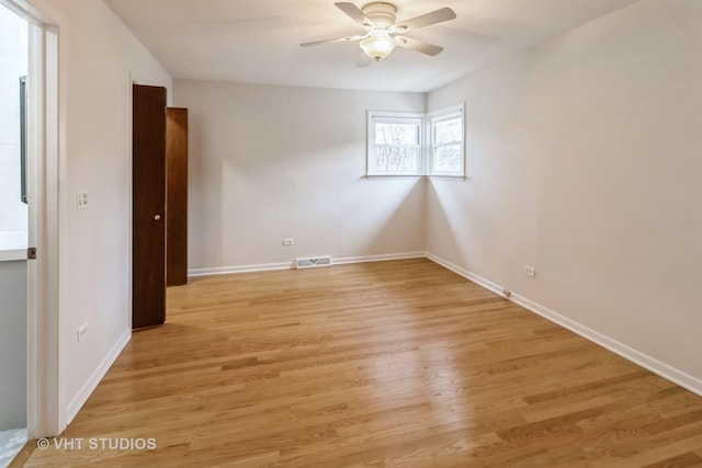 unfurnished room with ceiling fan and light wood-type flooring