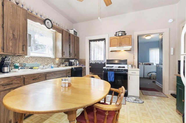 kitchen featuring range with gas cooktop, under cabinet range hood, light floors, dishwasher, and light countertops