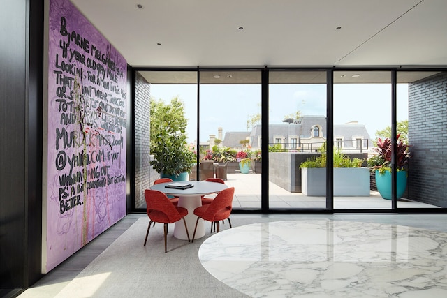 entryway featuring hardwood / wood-style flooring and a wall of windows