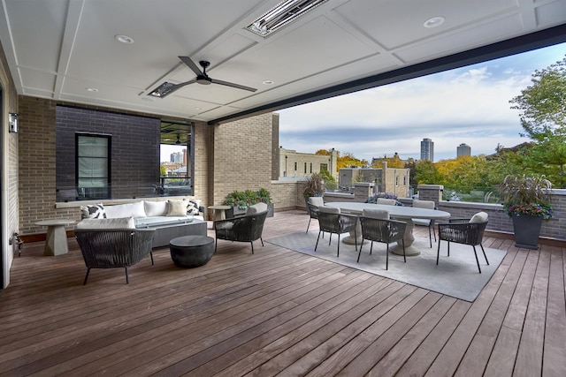 wooden deck featuring ceiling fan and an outdoor living space