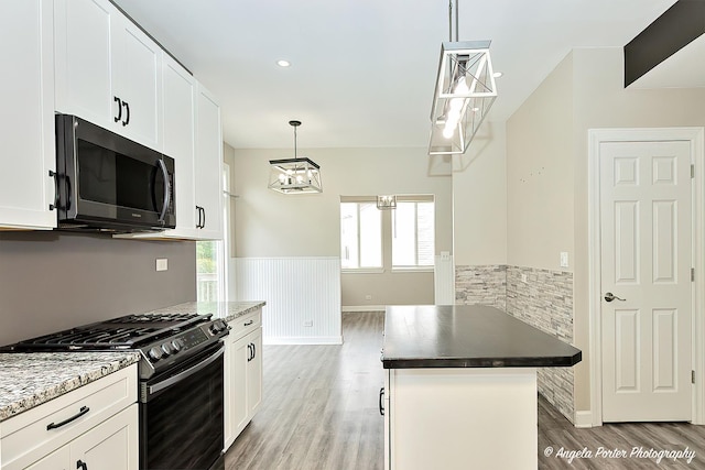 kitchen featuring white cabinetry, gas stove, dark hardwood / wood-style floors, and decorative light fixtures