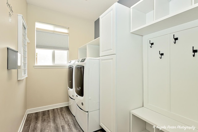 laundry room with cabinets, separate washer and dryer, and light hardwood / wood-style floors