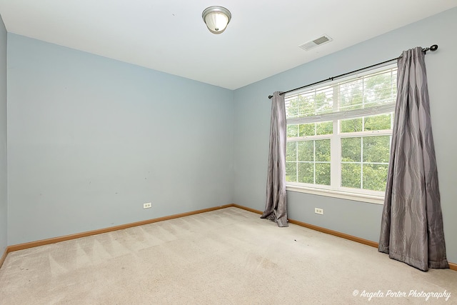 empty room featuring light colored carpet