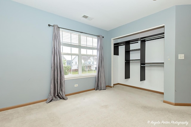 unfurnished bedroom with carpet flooring and a closet