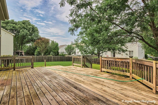 wooden deck featuring a yard