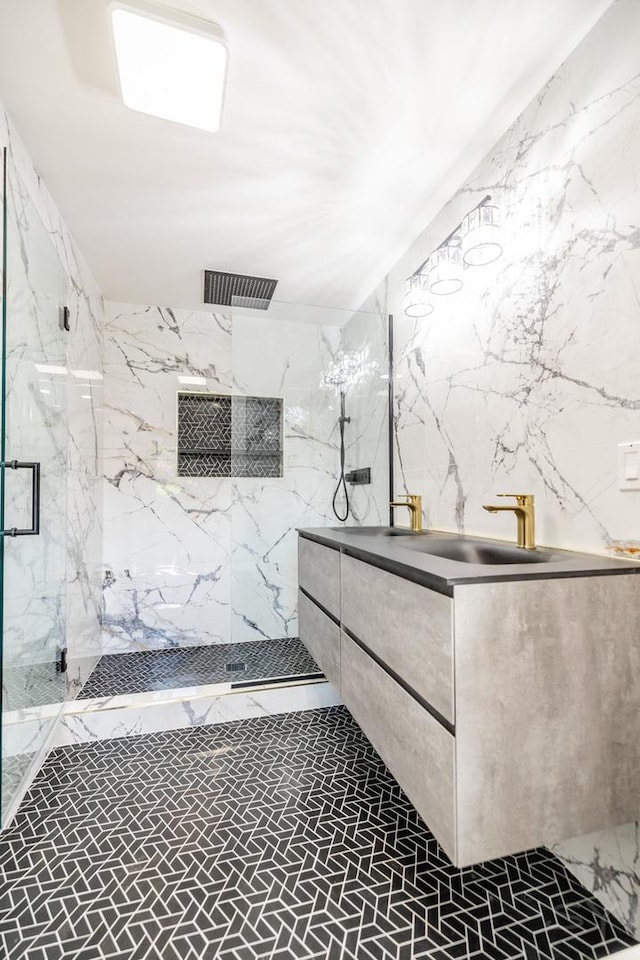 bathroom featuring a tile shower and vanity