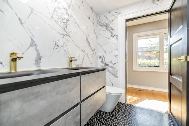 bathroom featuring vanity and toilet