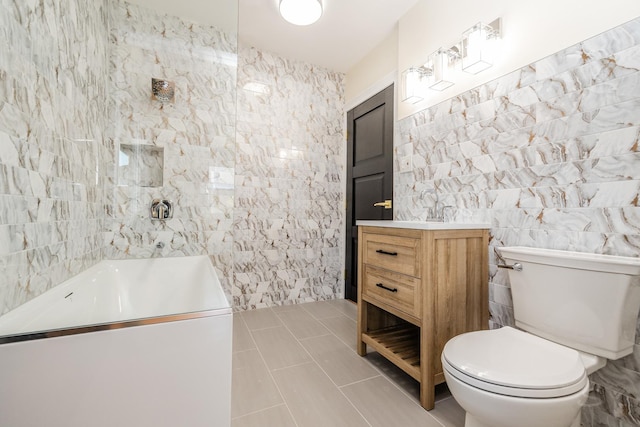 bathroom with vanity, tile walls, tile patterned floors, and toilet