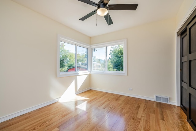 empty room featuring ceiling fan and light hardwood / wood-style flooring