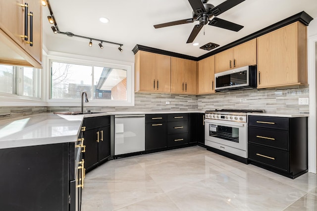 kitchen featuring sink, dishwasher, high end range, plenty of natural light, and light brown cabinetry