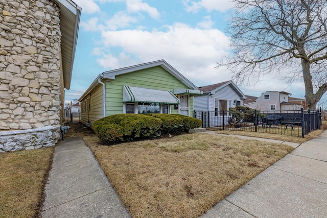 bungalow-style home with a front yard