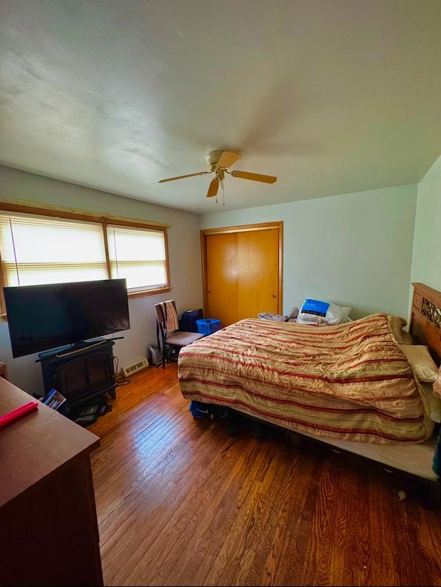 bedroom with wood-type flooring and ceiling fan