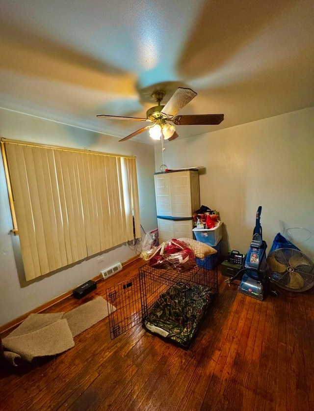 interior space with wood-type flooring and ceiling fan