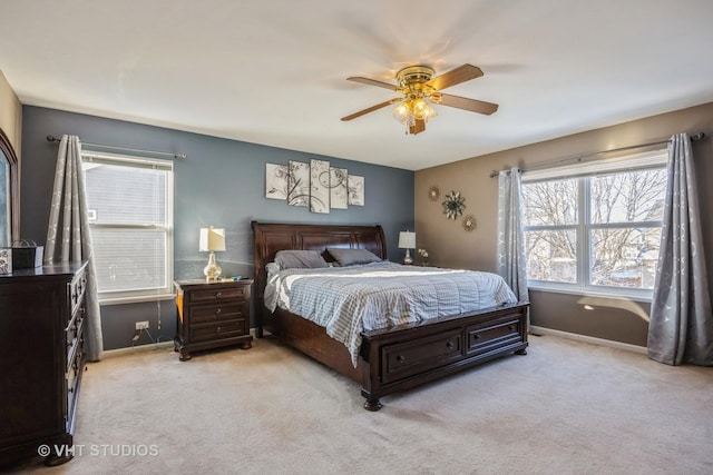 bedroom with ceiling fan and light carpet