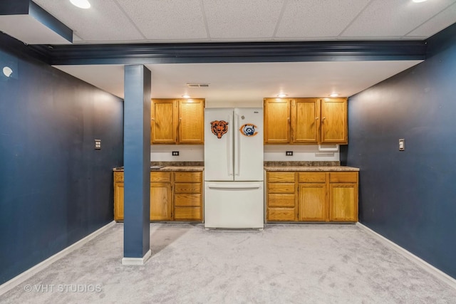 kitchen with light carpet and white refrigerator