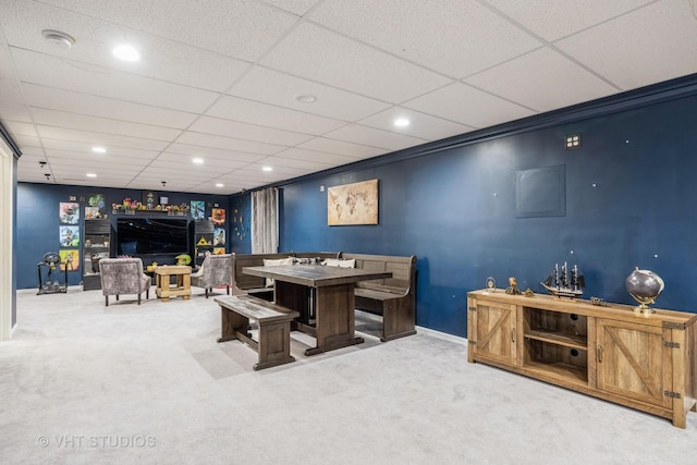 interior space featuring crown molding, carpet flooring, and a drop ceiling