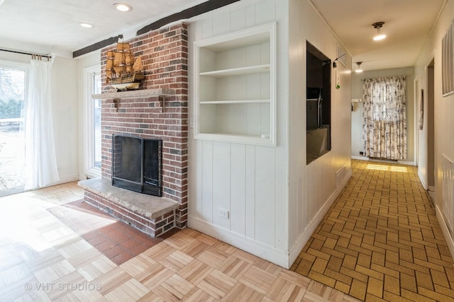 interior space with light parquet floors and built in features