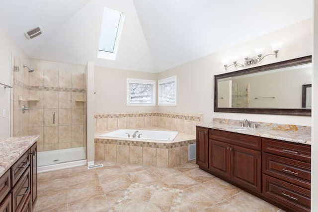 full bathroom featuring lofted ceiling with skylight, a stall shower, a garden tub, and vanity