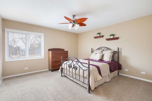 carpeted bedroom with baseboards and a ceiling fan