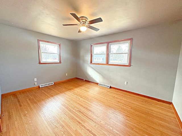 empty room featuring ceiling fan and light hardwood / wood-style flooring