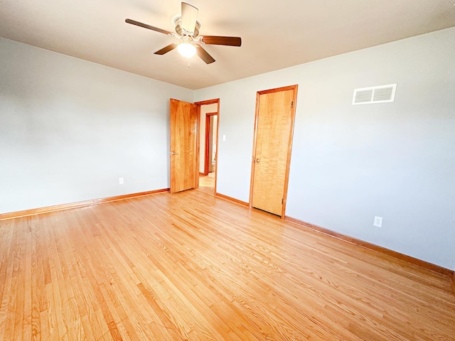 spare room featuring light hardwood / wood-style flooring and ceiling fan