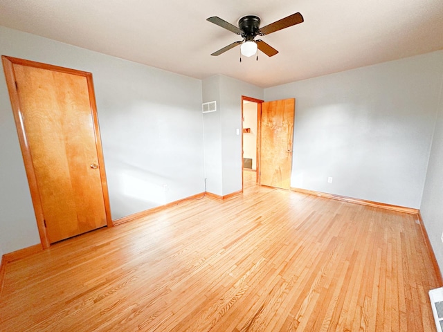 spare room with light hardwood / wood-style flooring and ceiling fan