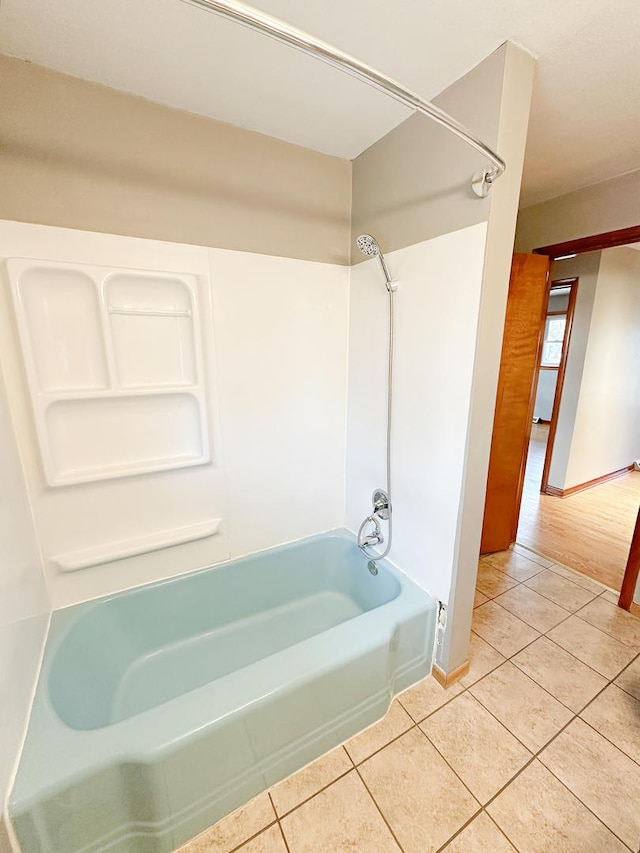 bathroom featuring washtub / shower combination and tile patterned floors