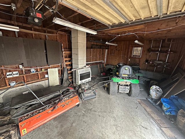 garage with a garage door opener and heating unit