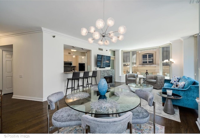 dining area featuring ornamental molding, an inviting chandelier, and dark hardwood / wood-style flooring