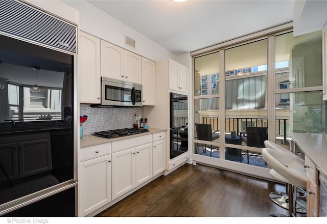 kitchen featuring dark wood-type flooring, sink, black appliances, decorative backsplash, and white cabinets