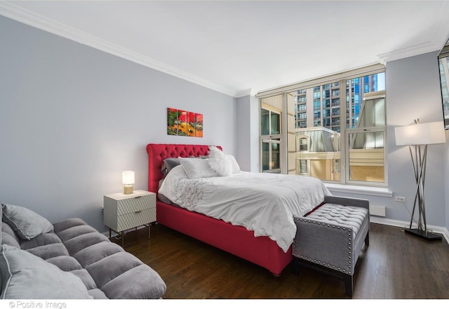 bedroom featuring crown molding and dark hardwood / wood-style floors